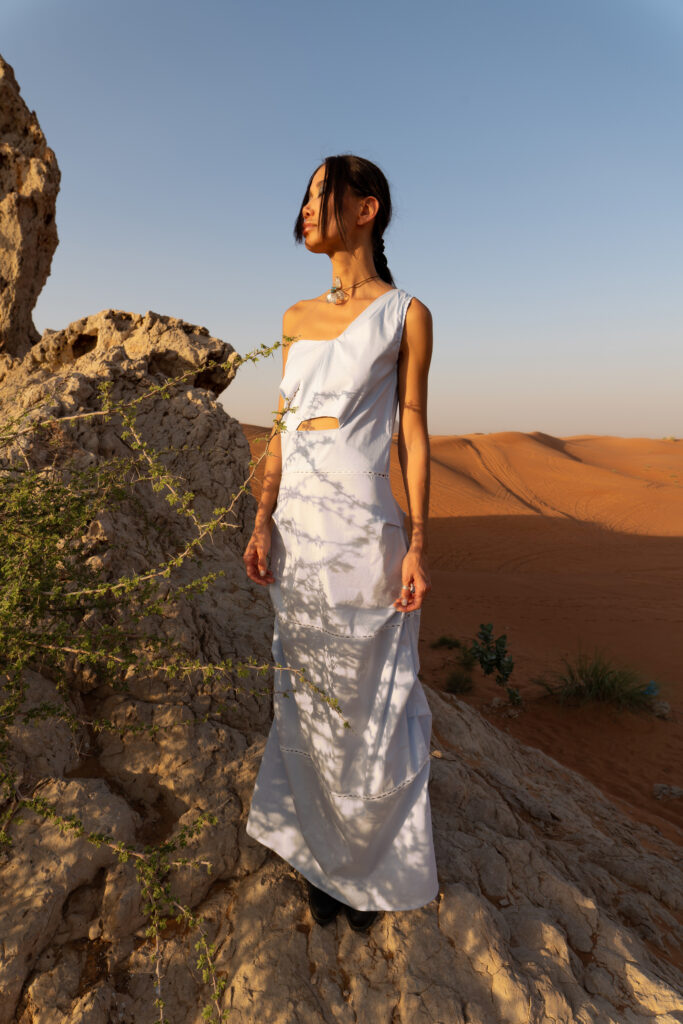 Model's silhouette against a golden desert sunset