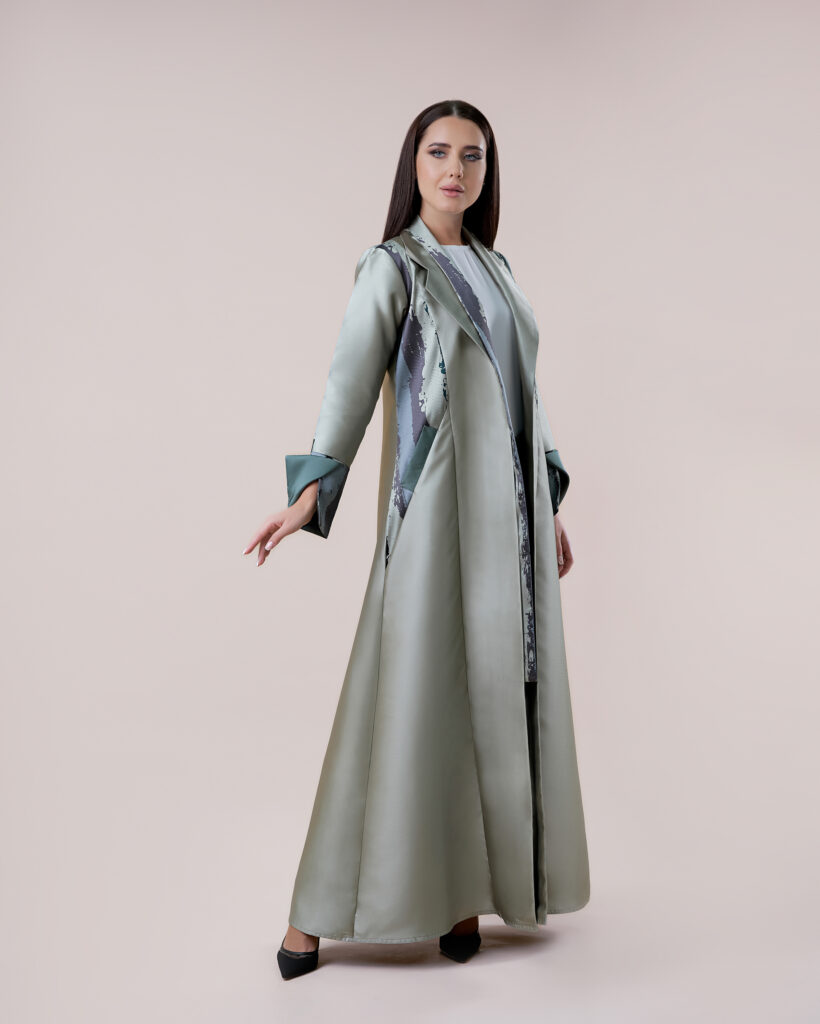 Model showcasing a designer abaya in a professional studio setting in Dubai.