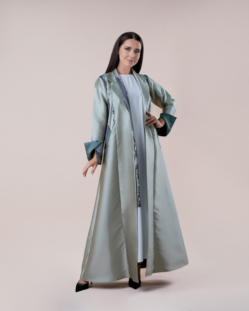 Model draped in an elegant abaya, captured in a studio setting.