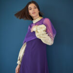 Designer Photoshoot with Fashion model in violet against vivid blue