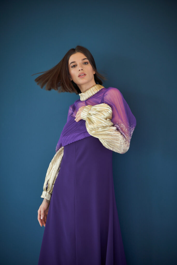 Designer Photoshoot with Fashion model in violet against vivid blue
