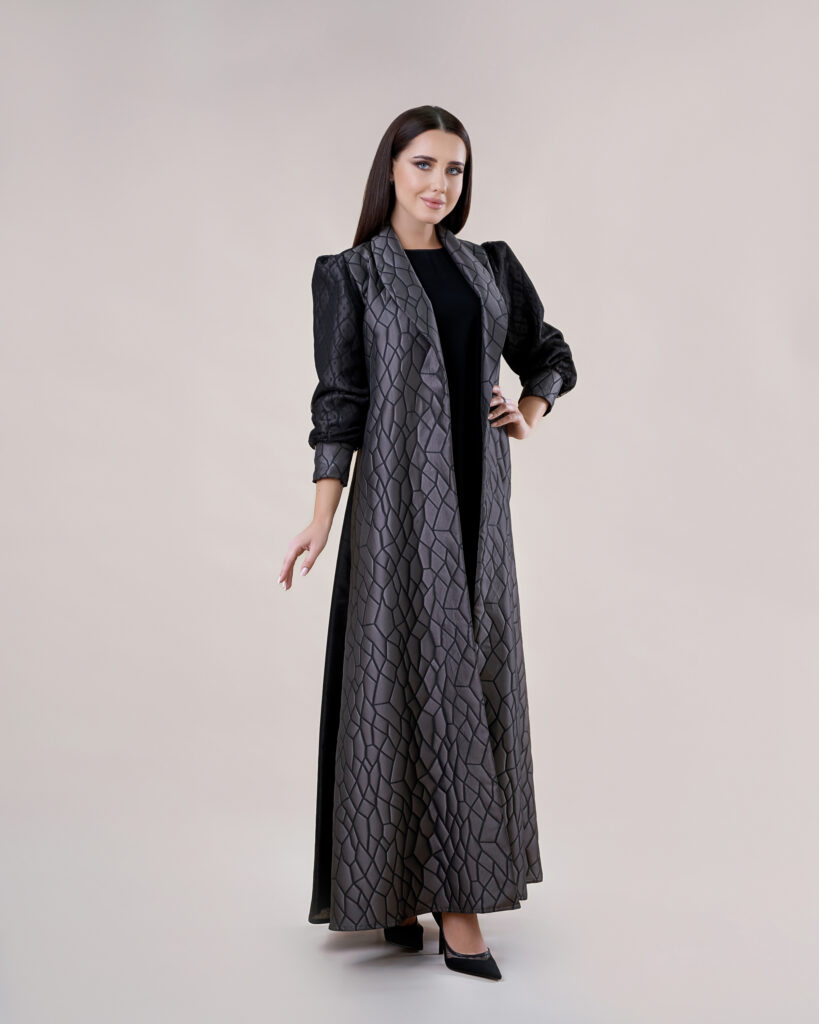 Model in a designer abaya, captured in pristine studio lighting.
