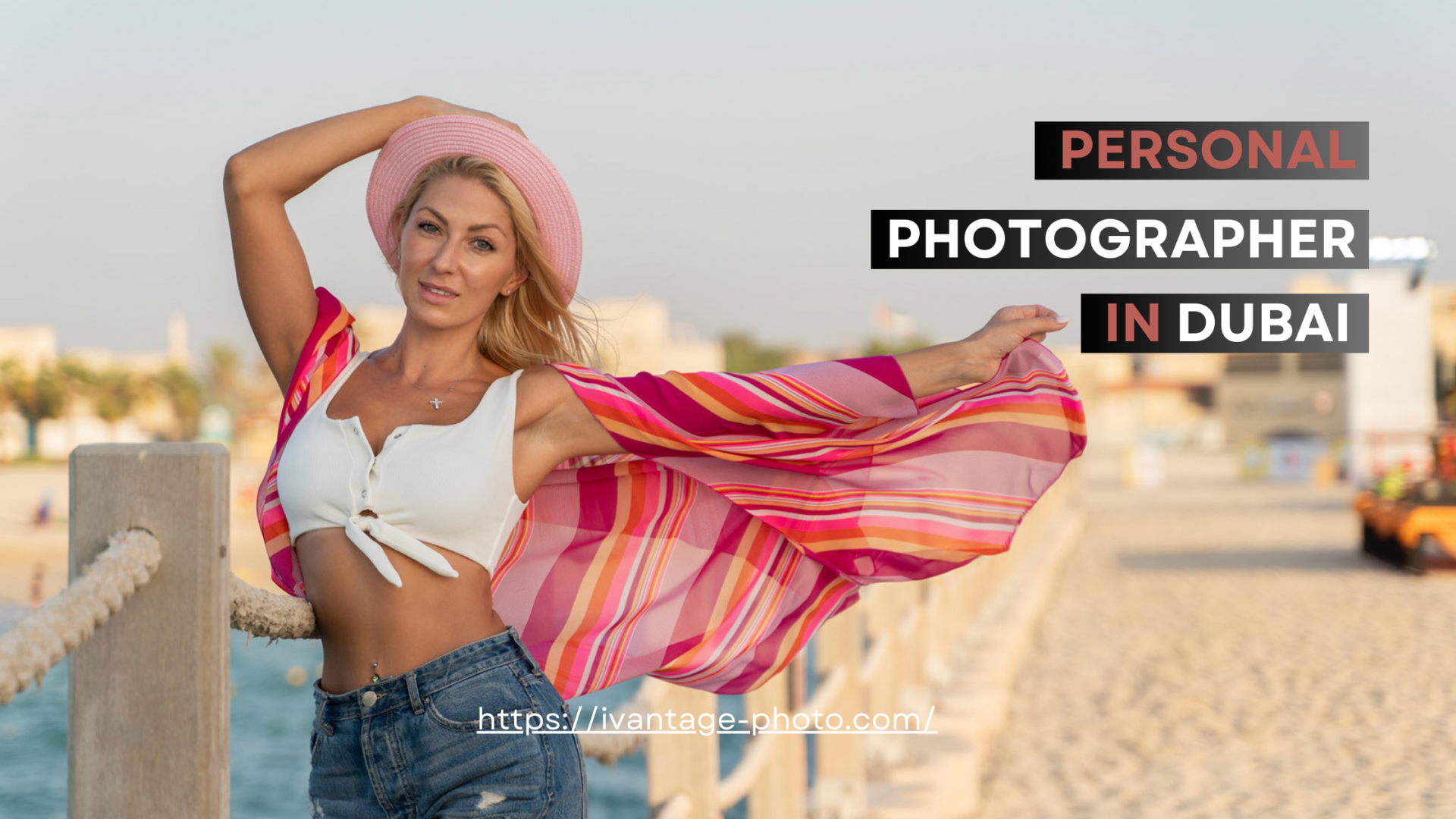 shooting by personal photographer in dubai Model in a summer outfit and hat on Dubai's coastline, with windswept hair.